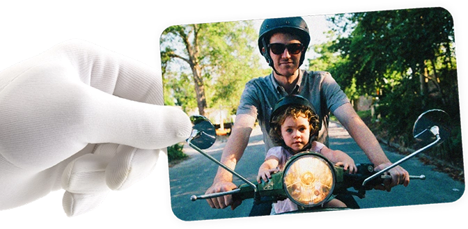 Hand holding photo of father and son